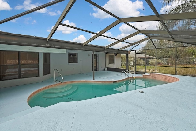 outdoor pool with glass enclosure and a patio