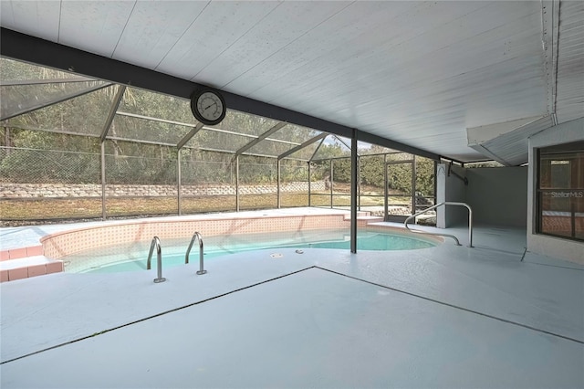 outdoor pool featuring a patio area and glass enclosure