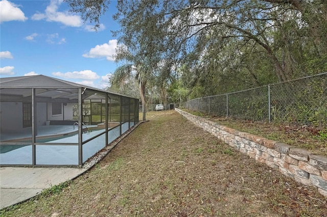 view of yard with a fenced backyard, a lanai, and a fenced in pool