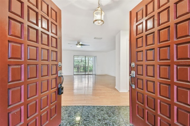 entrance foyer featuring ceiling fan, wood finished floors, and visible vents