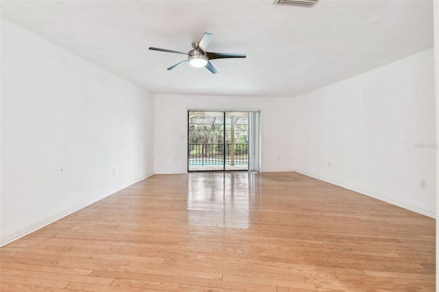 empty room featuring ceiling fan, baseboards, visible vents, and light wood-style floors