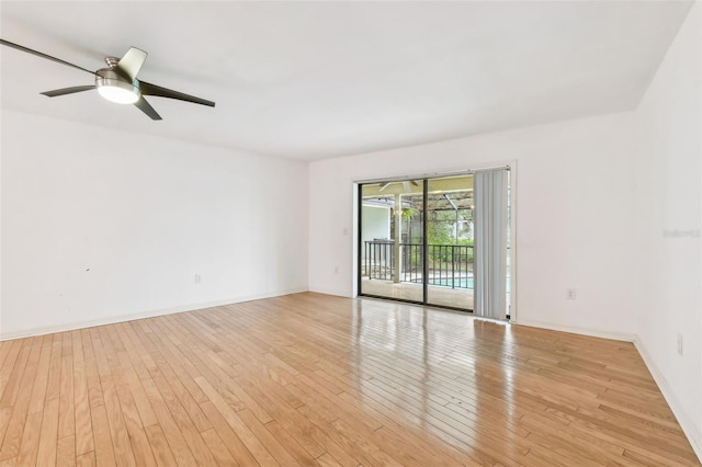 unfurnished room with baseboards, ceiling fan, and light wood finished floors