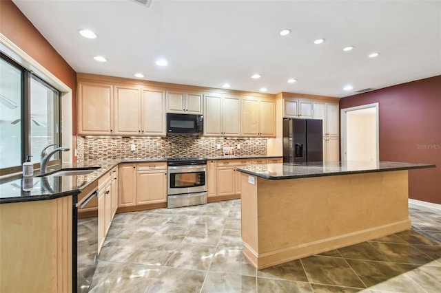 kitchen featuring a kitchen island, a sink, light brown cabinetry, black appliances, and backsplash