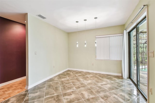 empty room with visible vents and baseboards