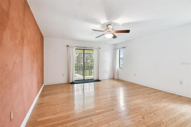 unfurnished room featuring baseboards, light wood-style flooring, and a ceiling fan