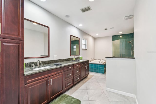 bathroom featuring visible vents, a sink, and a bath