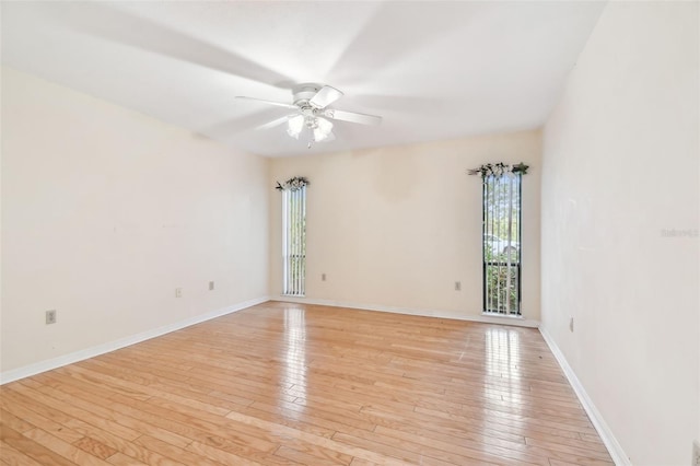 unfurnished room featuring light wood-type flooring, ceiling fan, and baseboards