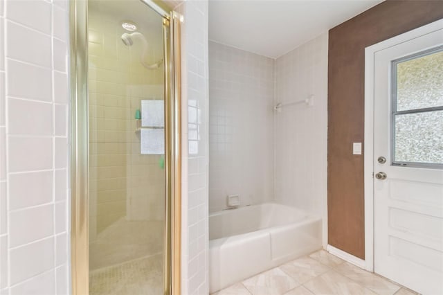 full bath with a stall shower, tile patterned flooring, and a garden tub