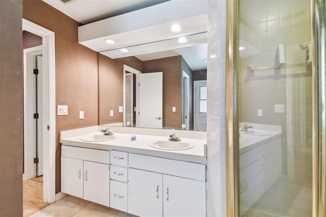 bathroom with double vanity, a stall shower, a sink, and recessed lighting