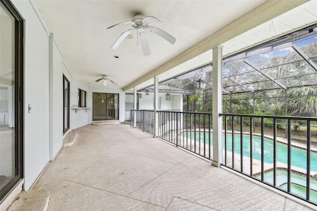 unfurnished sunroom with a ceiling fan