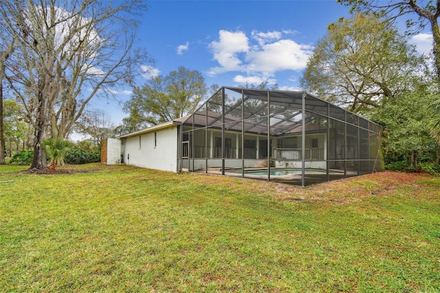 back of house featuring a yard, an outdoor pool, and stucco siding