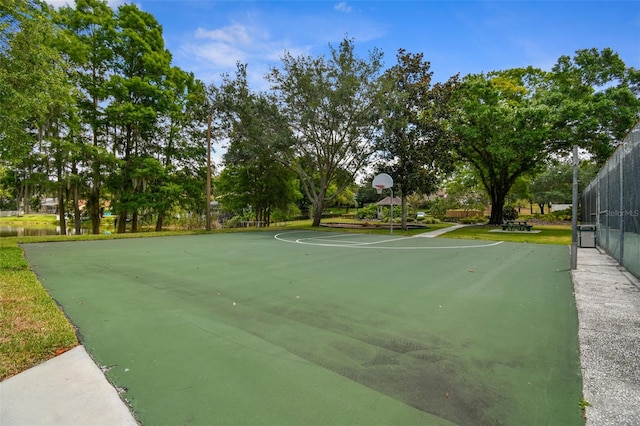 view of basketball court with community basketball court and fence