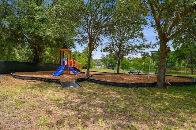 community jungle gym with a yard