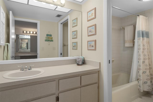 full bathroom featuring visible vents, shower / bathtub combination with curtain, and vanity