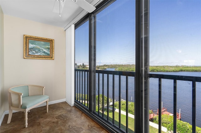 sunroom featuring a water view