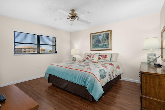 bedroom with a ceiling fan, dark wood finished floors, a textured ceiling, and baseboards