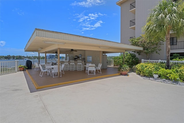 view of patio with fence and a ceiling fan