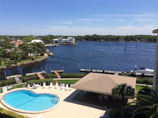 pool featuring a water view and a patio