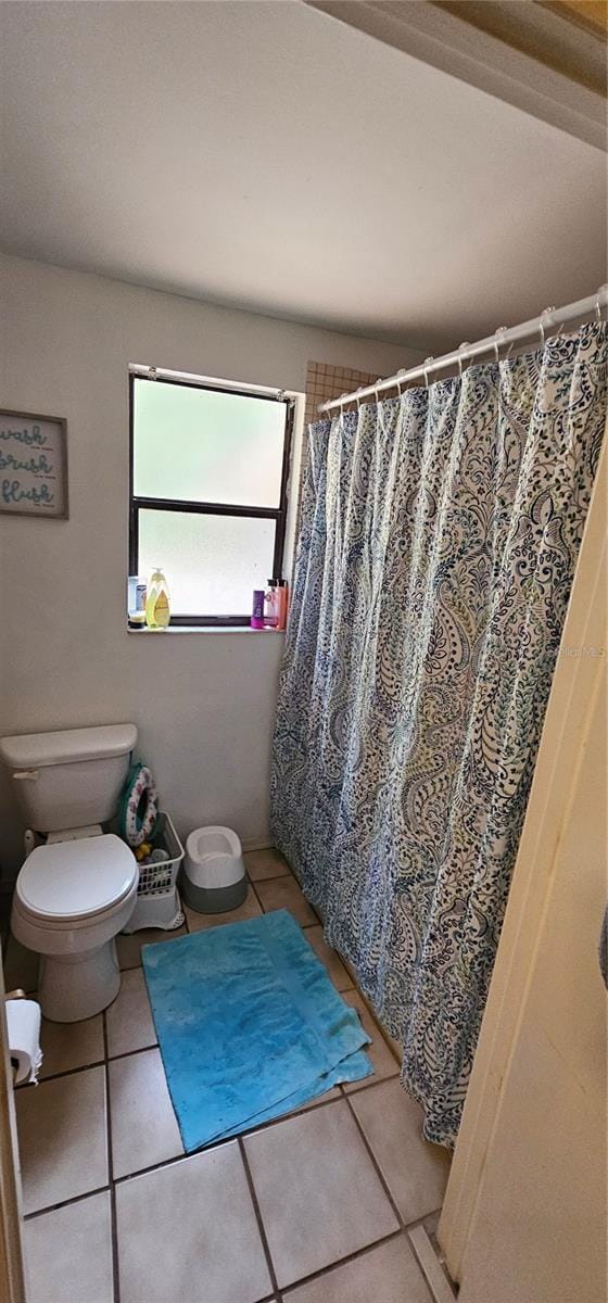 full bath with toilet and tile patterned flooring