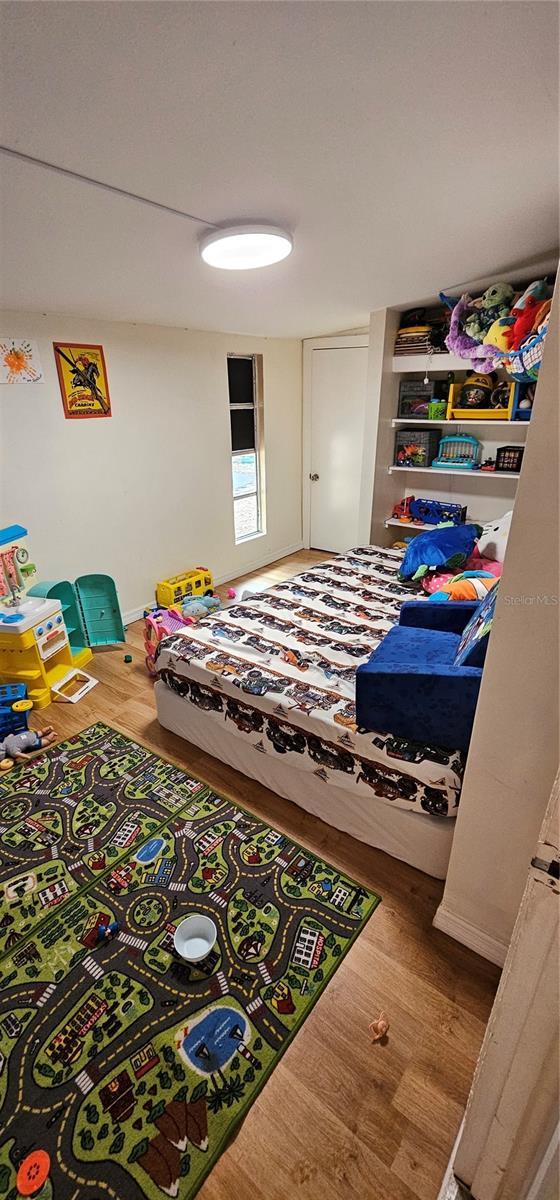 bedroom with wood finished floors