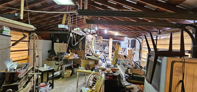 miscellaneous room with a garage and unfinished concrete floors