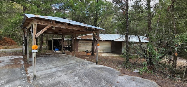 11617 Duda Rd, Hudson, FL 34667 - view of patio featuring a carport and a view of trees