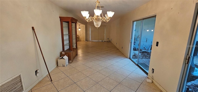 17932 Wendy Sue Ave, Hudson, FL 34667 - corridor featuring light tile patterned floors and a chandelier