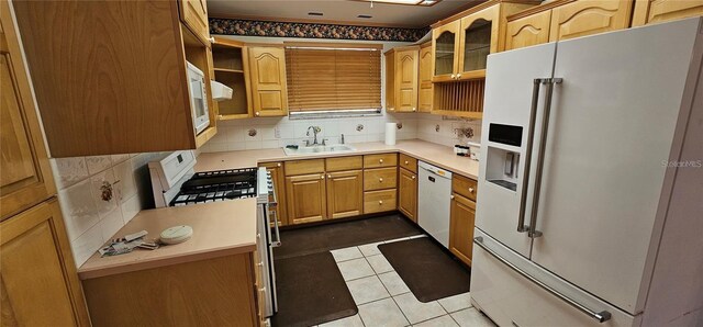 17932 Wendy Sue Ave, Hudson, FL 34667 - kitchen with white appliances, tasteful backsplash, glass insert cabinets, and light countertops