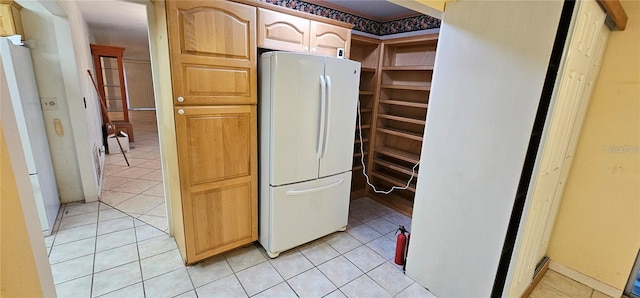 17932 Wendy Sue Ave, Hudson, FL 34667 - kitchen featuring freestanding refrigerator and light tile patterned floors