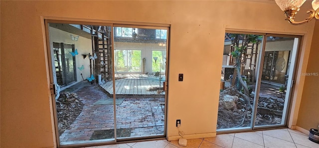 17932 Wendy Sue Ave, Hudson, FL 34667 - doorway with tile patterned flooring and a chandelier