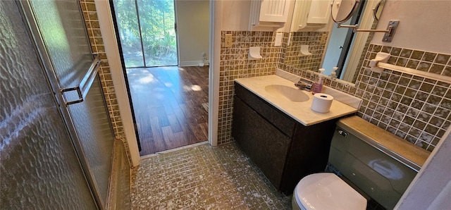 17932 Wendy Sue Ave, Hudson, FL 34667 - full bath featuring tile walls, vanity, an enclosed shower, and wood finished floors