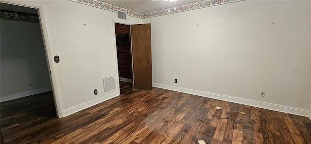 17932 Wendy Sue Ave, Hudson, FL 34667 - unfurnished bedroom with baseboards and dark wood-style floors