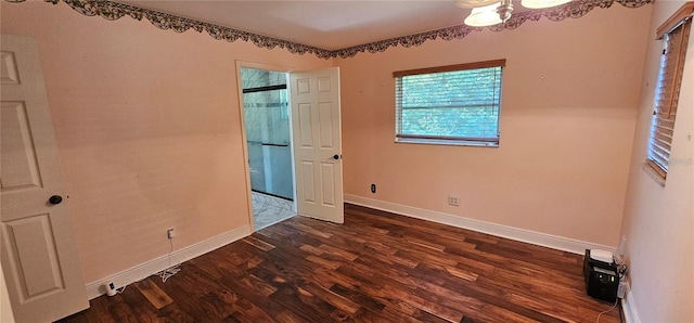 17932 Wendy Sue Ave, Hudson, FL 34667 - unfurnished bedroom featuring dark wood-type flooring and baseboards