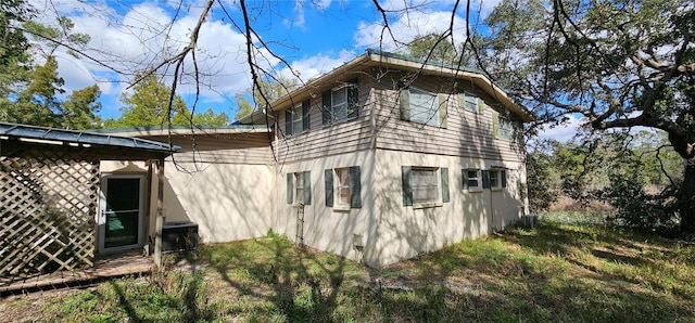 17932 Wendy Sue Ave, Hudson, FL 34667 - view of home's exterior featuring stucco siding and a cooling unit