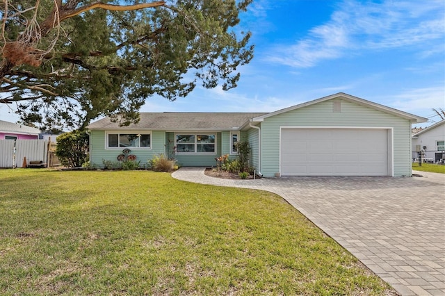 single story home featuring a front lawn, decorative driveway, an attached garage, and fence