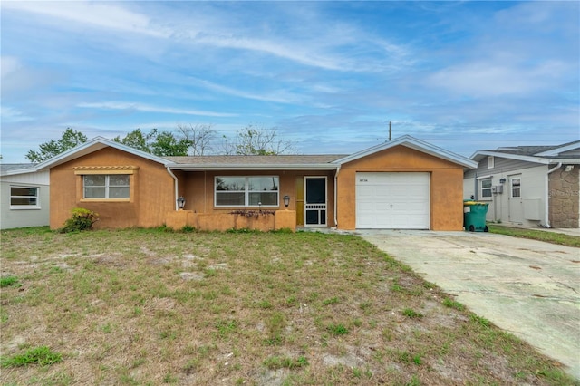 ranch-style house with a front yard, driveway, and an attached garage