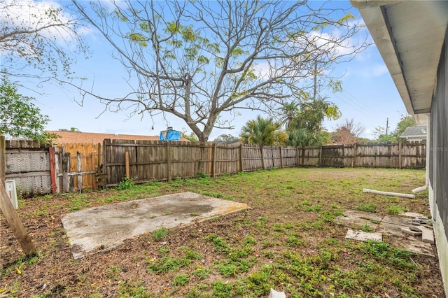 view of yard featuring a patio area and a fenced backyard