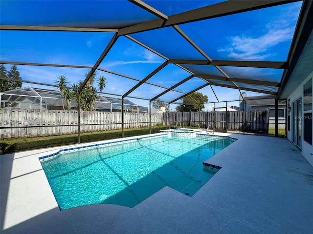 view of swimming pool featuring a lanai, fence, and a patio