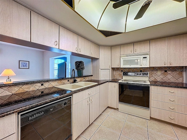 kitchen with decorative backsplash, electric stove, dishwasher, white microwave, and a sink