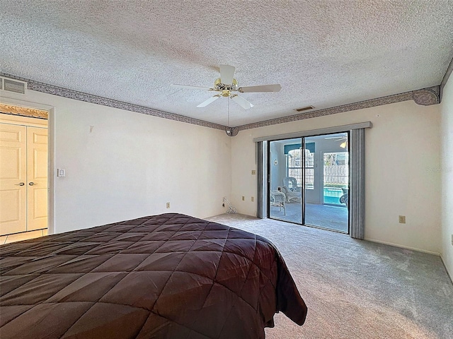 unfurnished bedroom with access to outside, carpet flooring, visible vents, and a textured ceiling