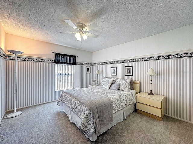 carpeted bedroom with a ceiling fan and a textured ceiling