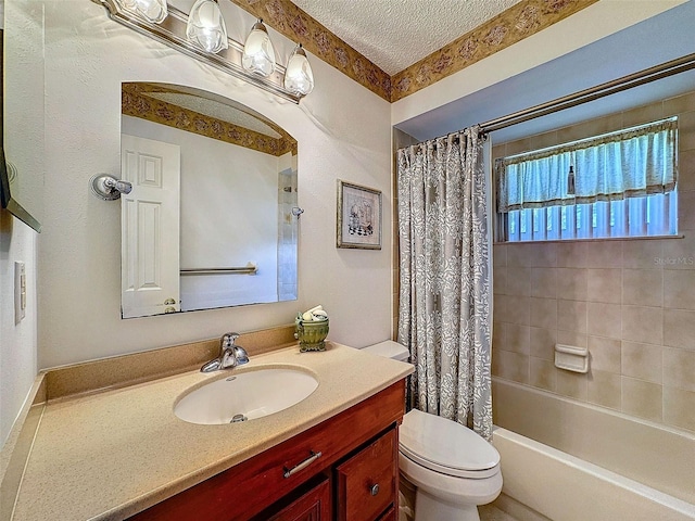 full bath featuring toilet, shower / bath combo, a textured ceiling, and vanity