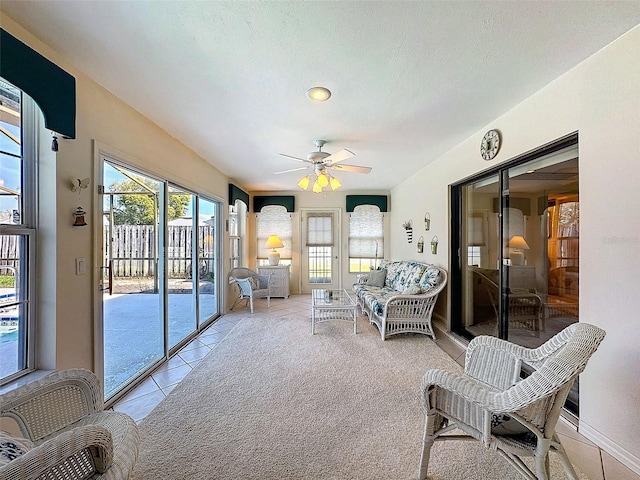 sunroom featuring a ceiling fan