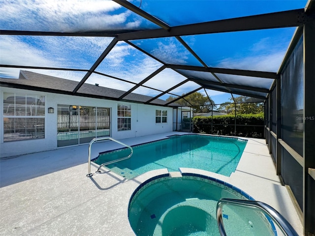 view of pool featuring a pool with connected hot tub, a patio, and a lanai