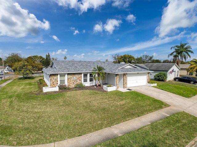 ranch-style home with a garage, a front yard, stone siding, and driveway