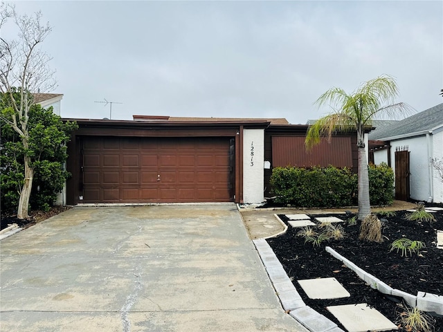 garage featuring concrete driveway