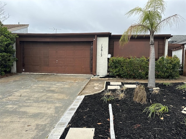 garage with concrete driveway