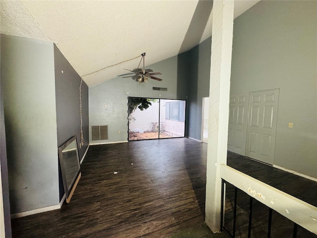 unfurnished living room with high vaulted ceiling, dark wood-type flooring, visible vents, and a ceiling fan