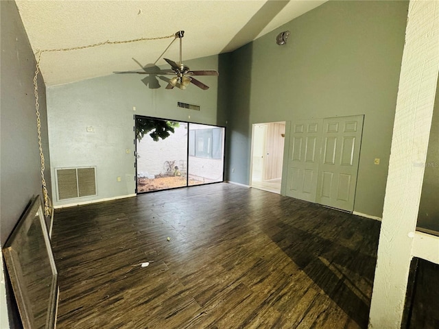 unfurnished living room featuring baseboards, dark wood-type flooring, visible vents, and a ceiling fan