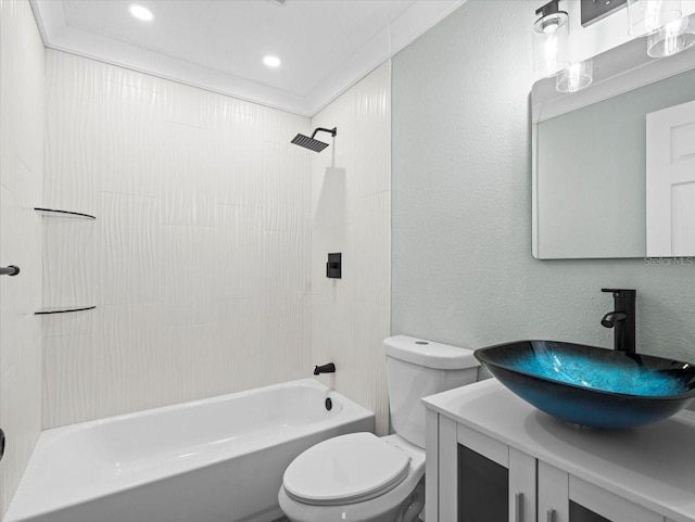 bathroom with crown molding, shower / bath combination, a textured wall, toilet, and vanity